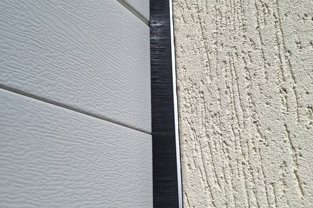Garage door brush seal installation to help reduce dust, leaves and pests