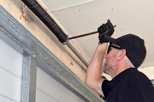 Garage door technician repairing a garage door in Perth